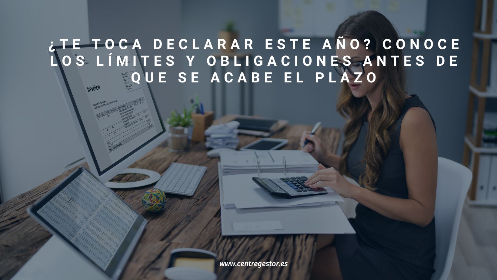 Empresaria gestionando su declaración de la renta con calculadora, ordenador y documentos, obligada a presentar su declaración ante Hacienda