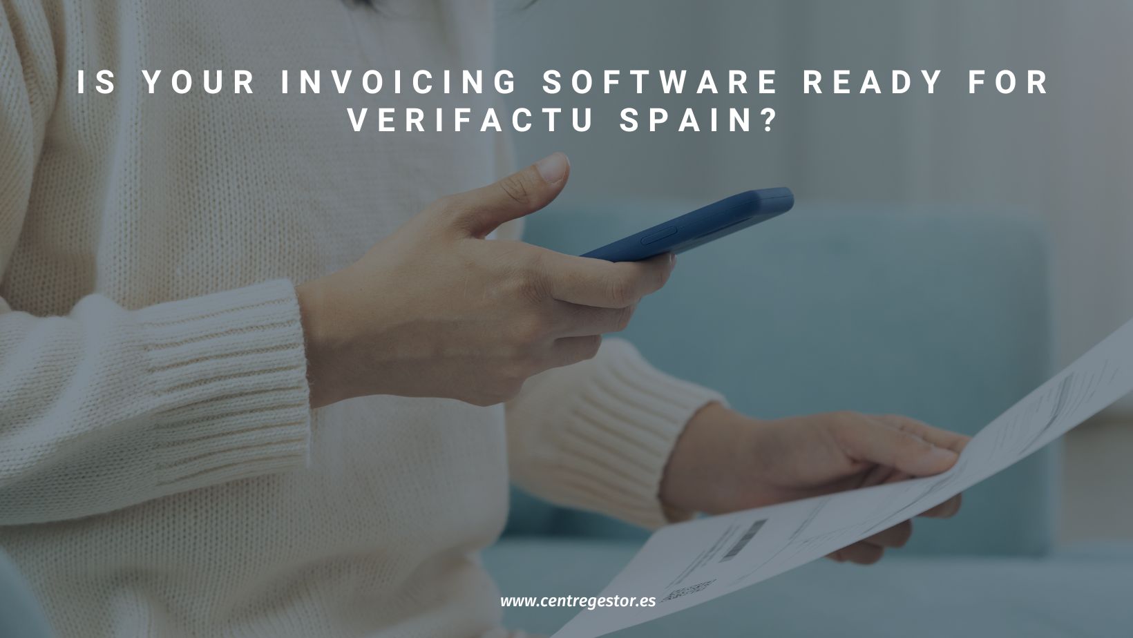 Person holding a smartphone and checking an invoice — concept of verifying invoicing software compliance with Verifactu Spain regulation.